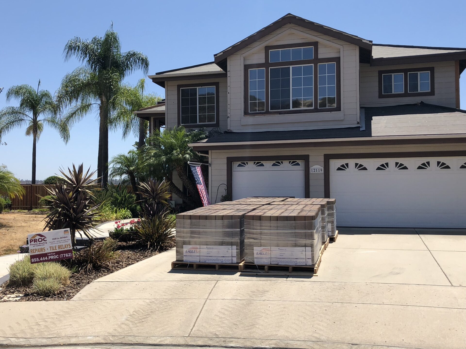 A house with two large boxes in front of it.